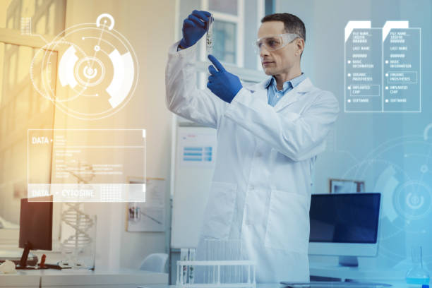 istock Calm scientist looking at the sample in a test tube and thinking 966369718
