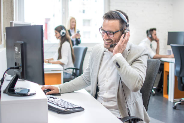 istock Portrait of happy smiling customer support phone operator at workplace. 966373668