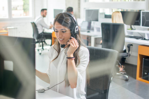 istock Beautiful young woman telephone operator agent talking using headset in customer support helpline centre 966374752