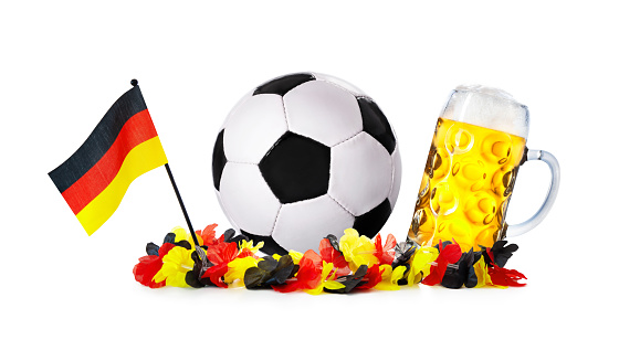 Glass with beer, soccer ball with german flag and flower chain isolated on a white background