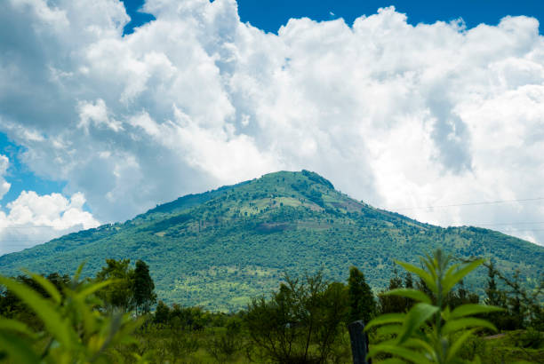 istock Summer landscape with mountains, cloudy sky, green grass and trees in Guatemala. 966375098