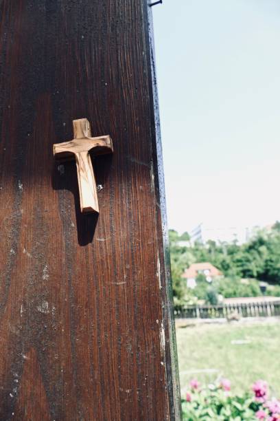 istock Crucifix on a wooden beam outside 966375388