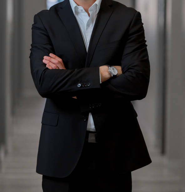 istock Cropped Head Man standing in a smart suit 966379492
