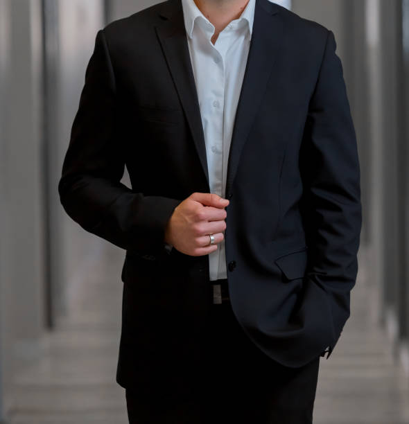 istock Cropped Head Man standing in a smart suit 966379506