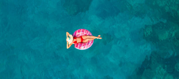 istock Swimming in clear turquoise sea 966379638