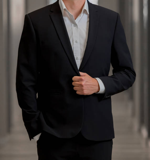 istock Cropped Head Man standing in a smart suit 966379814