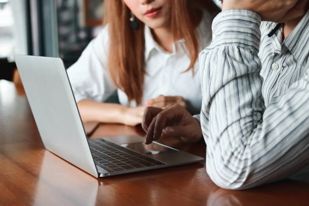 istock Team work business concept. Cropped image of people using laptop in workplace in office. 966380540