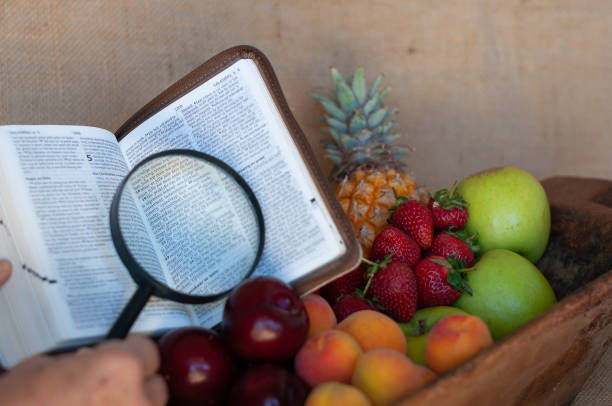 istock fruit bowl with bible and magnifying glass 966380552