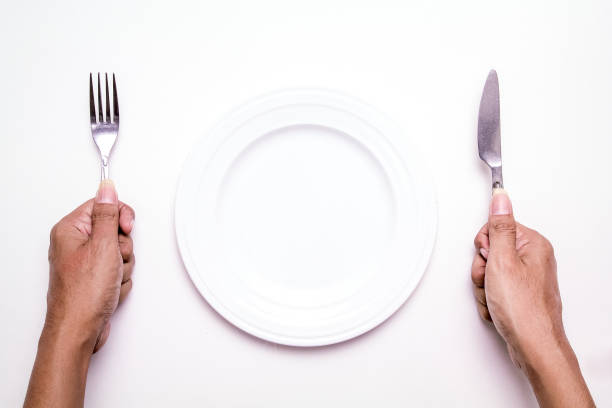 istock Isolated Empty White Plate with Hands Holding Cutlery 966380696