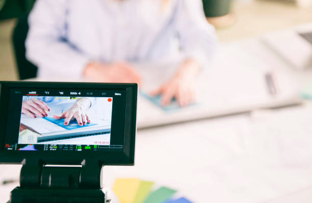 istock Filming video of architect working in office with professional video camera 966385438