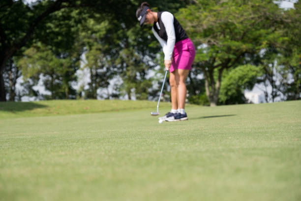 istock Woman golfer takes a long putt 966394004