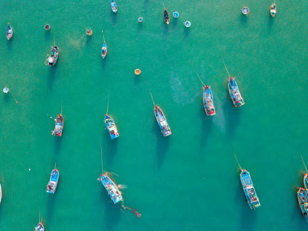 Top view, aerial view fishing harbour from drone Top view, aerial view fishing harbour market from drone. Royalty high quality free stock image of market at Mui Ne fishing harbour or fishing village. Fishing harbor is a popular tourist destination mui ne bay photos stock pictures, royalty-free photos & images