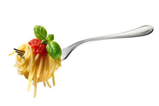 Fork of spaghetti with tomato sauce and basil Appetizing spaghetti rolled on fork with typical Italian sauce noodles stock pictures, royalty-free photos & images