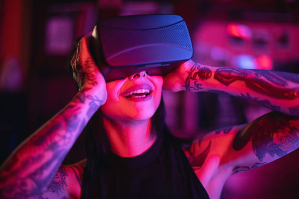 istock Young woman looks fascinated into Virtual Reality Headset 966403136