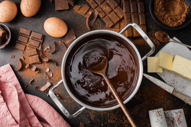 Ingredients for cooking chocolate pastry from above Top View of the process of cooking chocolate bakery pastry with melting chocolate. Ingredients for cooking chocolate sweet pie photos stock pictures, royalty-free photos & images