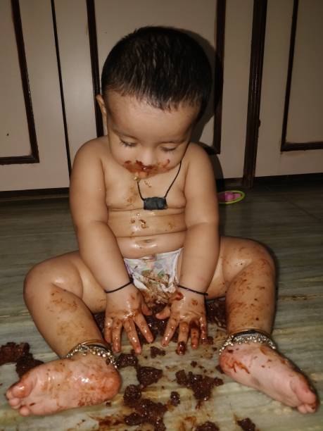 istock Adorable baby girl making mess while feeding herself 966412036