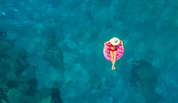 Aerial view of swimming in clear turquoise water. Mediterranean sea.