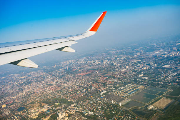 istock View of plane wing with cityscape 966412320