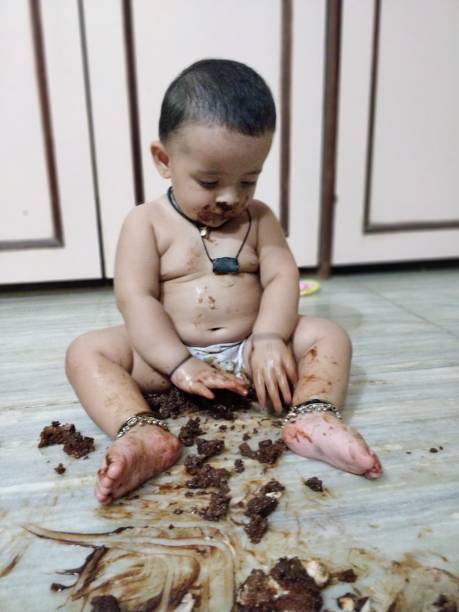 istock Adorable baby girl making mess while feeding herself 966414674