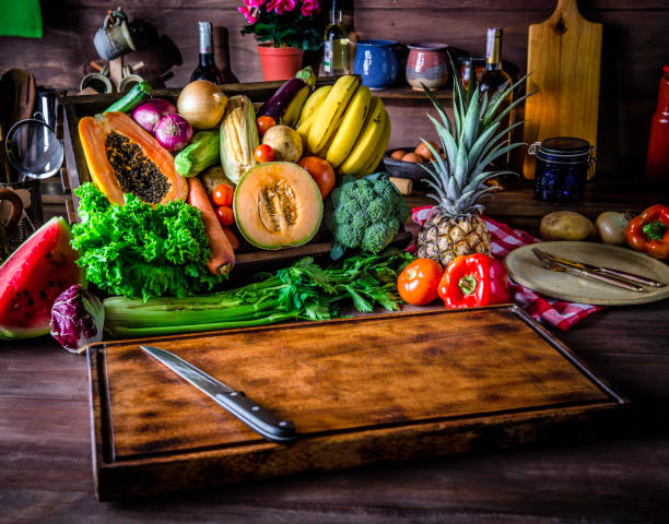 istock Cutting board in a rustic kitchen ready to cut and process organic tropical fruits and vegetables. Natural lighting 966416092