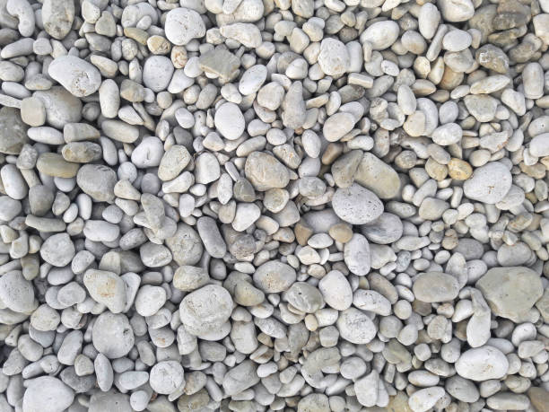 istock Sea round glossy stones background, top view. 966416456