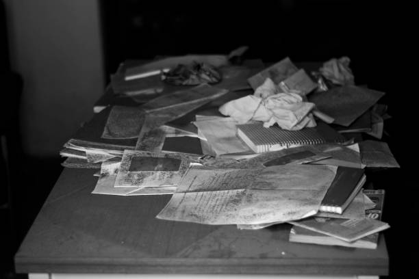 istock Abandoned documents on table in abandoned building photo black and white 966416482