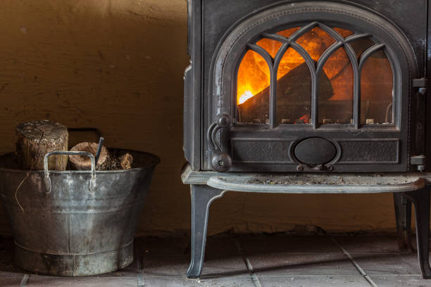 istock Fireplace with orange fire flame and firewood beside 966418590