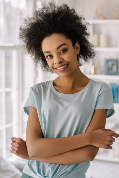 istock Young african american woman smiling posing at home 966419032