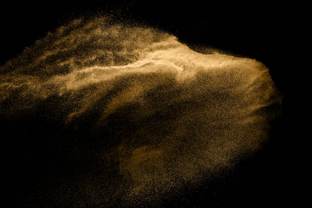 istock Abstract sand cloud. Golden colored sand splash agianst dark background. Yellow sand fly wave in the air. Sand explode on black background ,throwing freeze stop motion. 966419586
