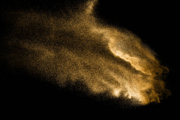 istock Abstract sand cloud. Golden colored sand splash agianst dark background. Yellow sand fly wave in the air. Sand explode on black background ,throwing freeze stop motion. 966419644