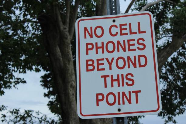 istock No cell phones beyond this point sign on pole 966434354