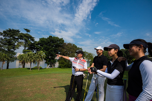 Team of male and female golfers discussing the game