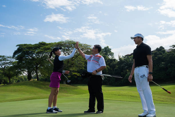 istock Golfers celebrating the game with a high five 966435256
