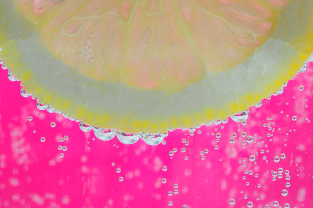 a slice of lemon in a glass with sparkling water