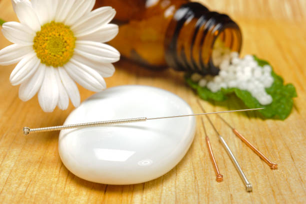 istock alternative medicine with homeopathic pills and acupuncture 966437900