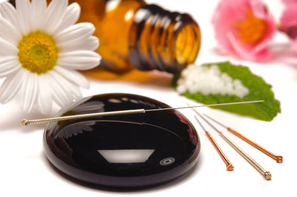 istock alternative medicine with homeopathic pills and acupuncture 966438376