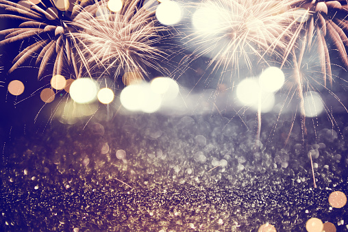 Gold and dark blue Fireworks and bokeh glitter in New Year eve and copy space. Abstract background holiday.