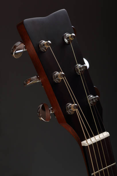 istock Six-stringed wooden acoustic guitar head with tuning pegs 966446300