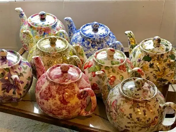 A collection of Vintage Tea Pots with a retro flower pattern.