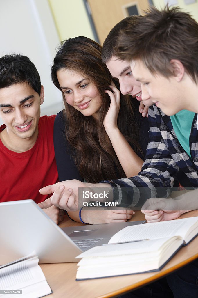 happy young students studying on a laptop in colleage classroom  High School Stock Photo