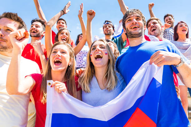 istock Russian supporters celebrating at stadium with flags 966478034