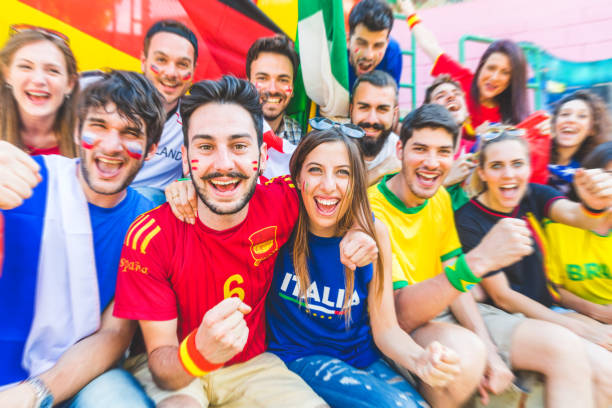 istock Football supporters together at stadium during a match 966478126
