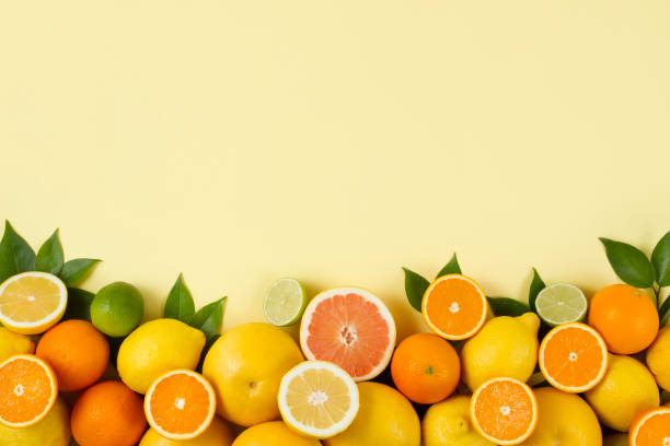 istock Citrus Fruits on Yellow Background 966478702