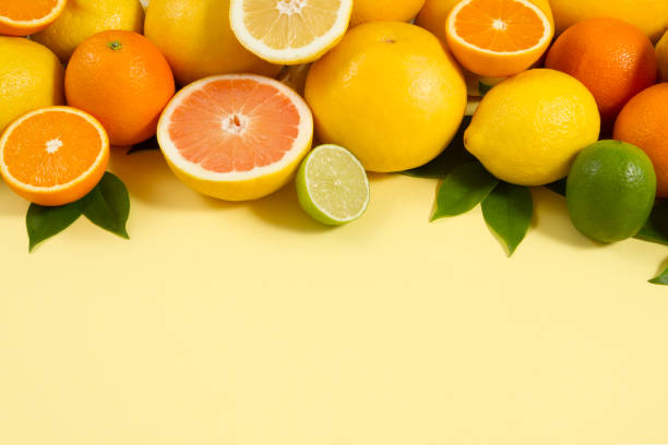 istock Citrus Fruits on Yellow Background 966478794