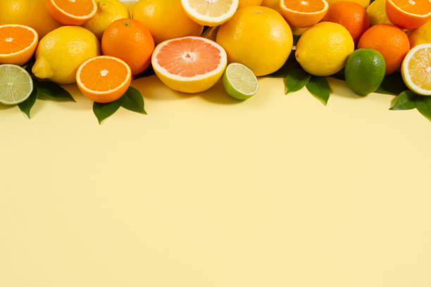 istock Citrus Fruits on Yellow Background 966478830