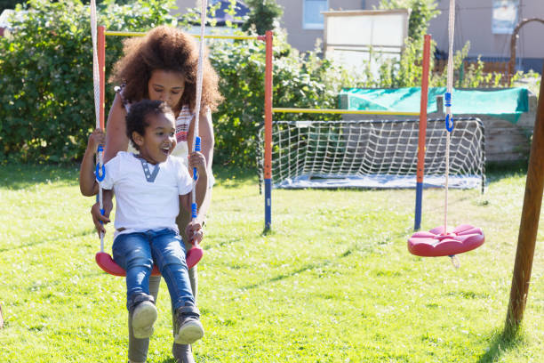 istock african mother with toddler boy on playground 966489348