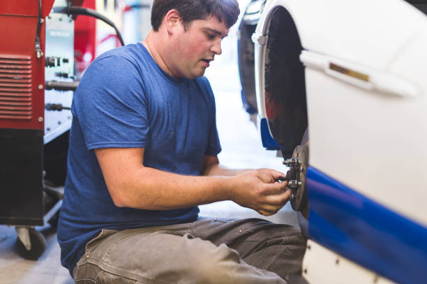 istock Auto mechanic works on his race car in the garage 966489834