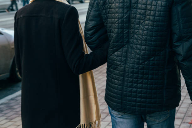 istock a couple walks, walks through the city, holding hands, arm, rear view. 966493162