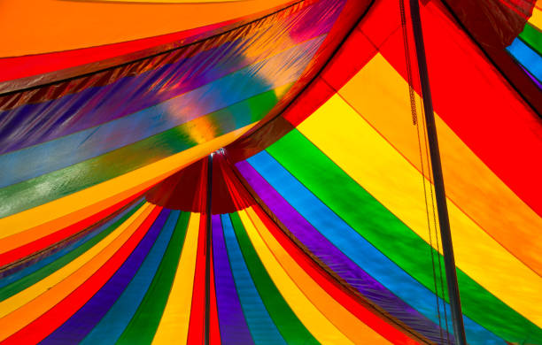 Inside of colorful striped tent used for events and parties.