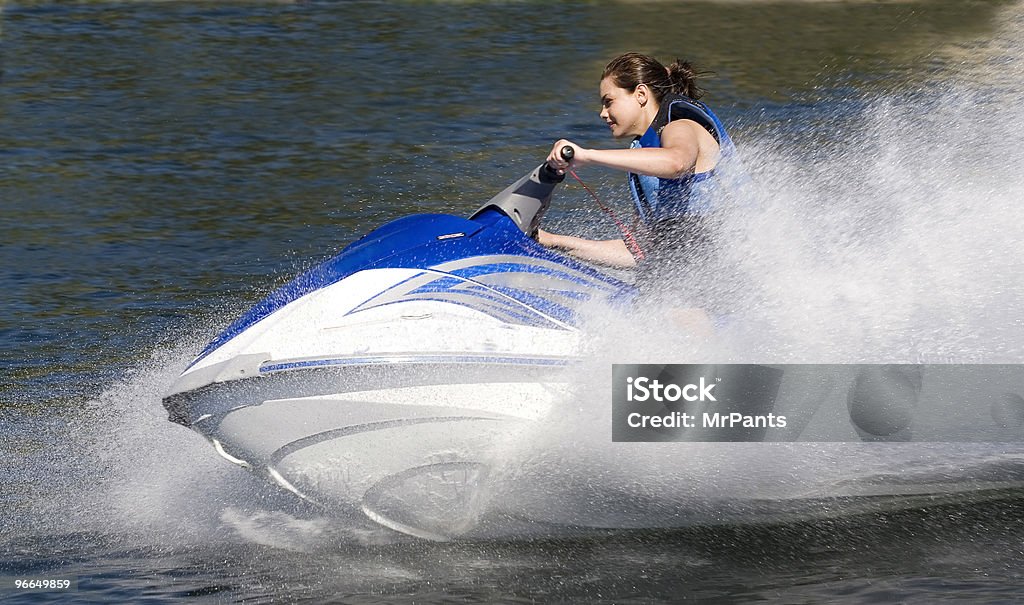 Action Photo of Young Woman on Seadoo Watercraft with Water-Spray Close-up side view action photo of a young woman on a sporty Seadoo watercraft with water spray  Personal Watercraft Stock Photo